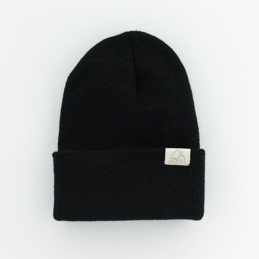 The seaslope1 JET INFANT/TODDLER BEANIE is made from 100% acrylic and features a sleek black design with a folded brim. It's crafted in the USA and is presented against a plain white background.