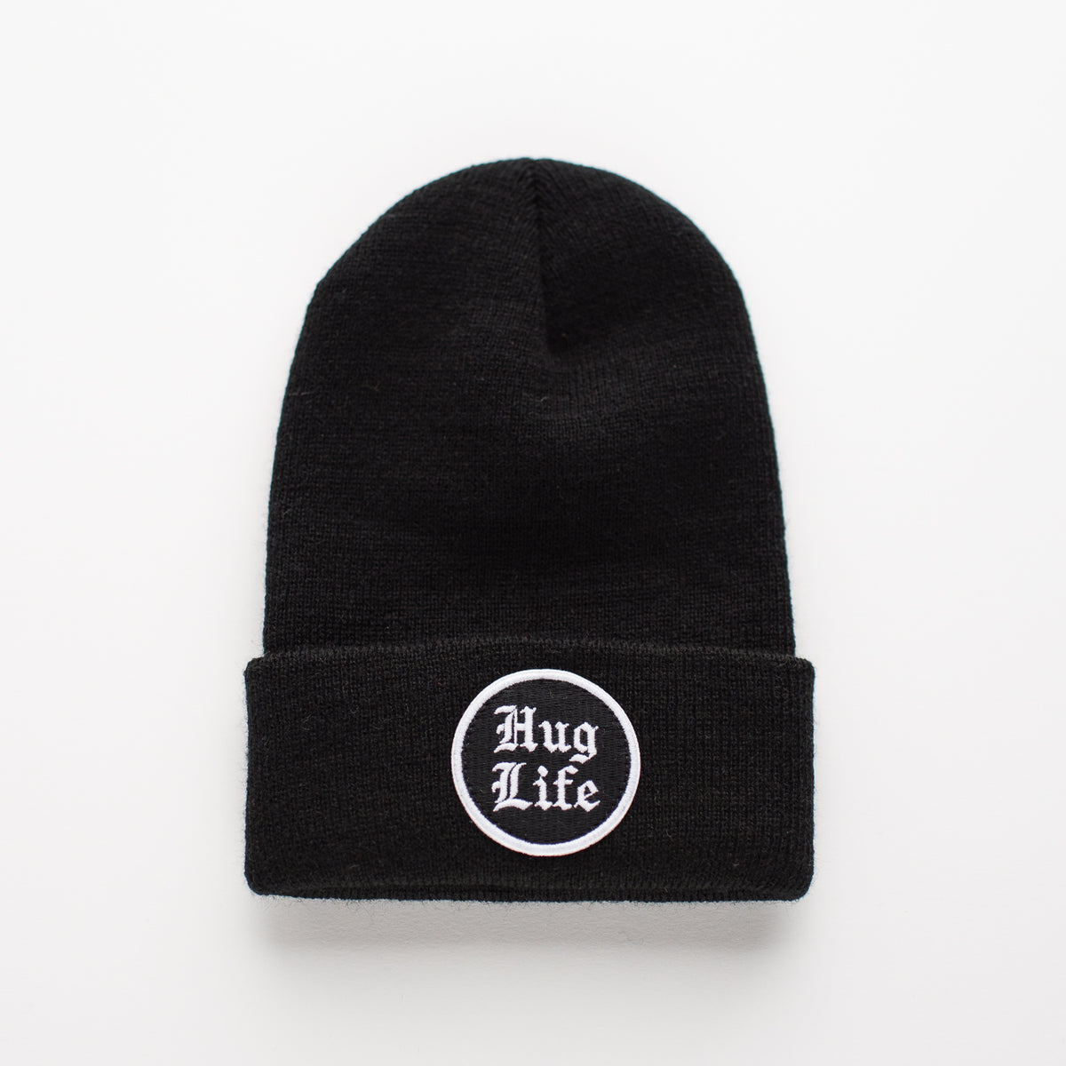 Introducing the "Hug Life - Jet Black Kids Beanie." Crafted entirely from high-quality acrylic, this sleek beanie features "Thug Life" in stylish Gothic script on an embroidered patch. Its rich black color stands out vividly against a plain white background, highlighting its bold design and smooth finish.