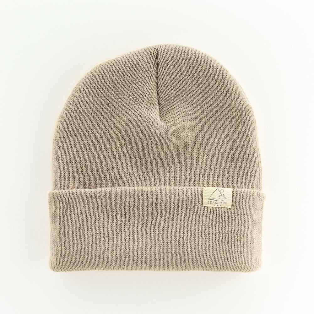 The SAND YOUTH/ADULT BEANIE by seaslope1 is a light brown, 100% acrylic knit beanie with a folded brim, proudly made in the USA.