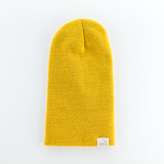 A vibrant yellow SUN INFANT/TODDLER BEANIE from seaslope1, crafted from 100% acrylic for a comfortably soft stretch fit, rests on a white surface. A small label is stitched at the bottom edge.